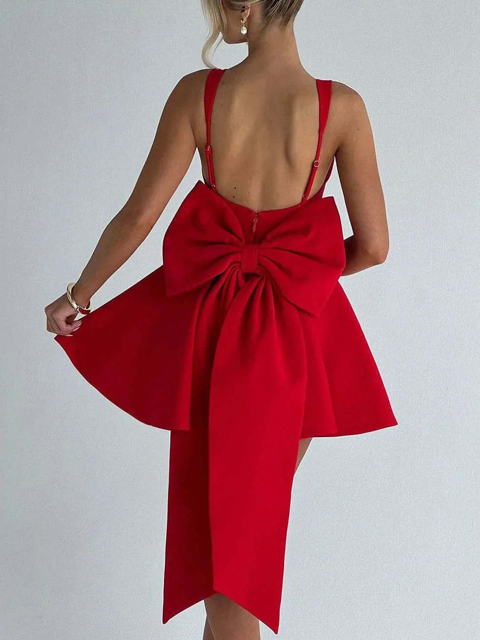 Red mini dress back view showing open back and large bow detail