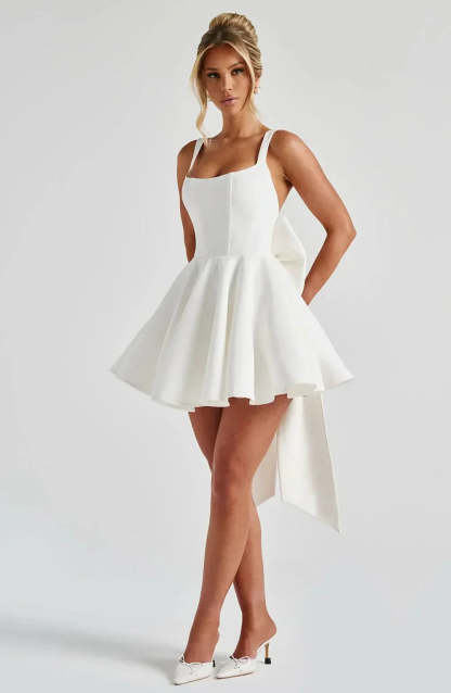 Cream fit-and-flare mini dress with side pockets and flowing skirt