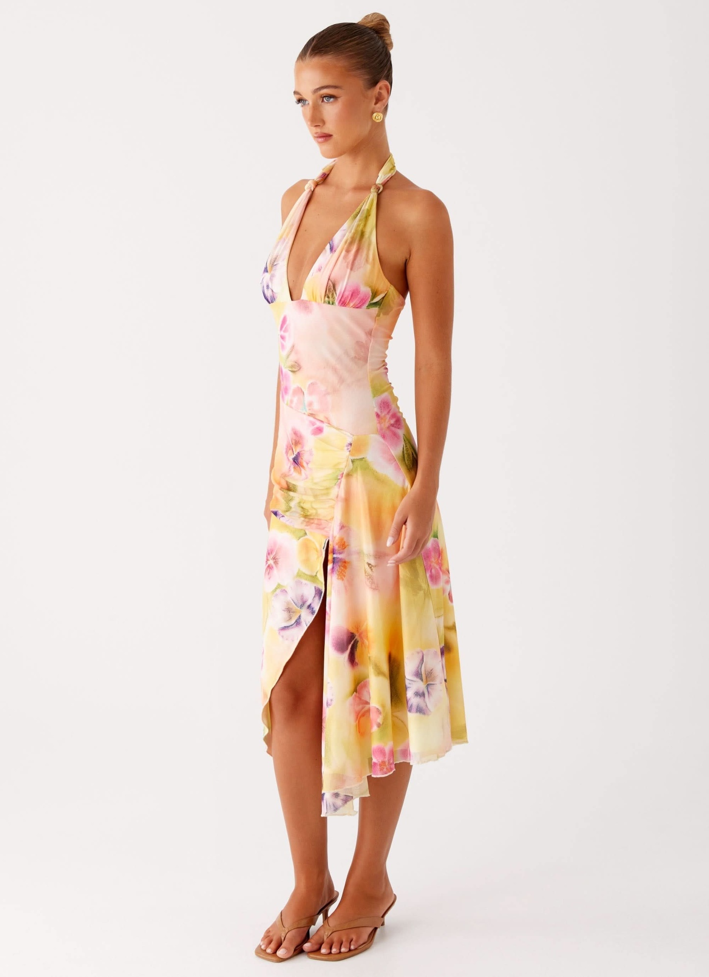 Side view of floral wrap midi dress with asymmetrical hemline