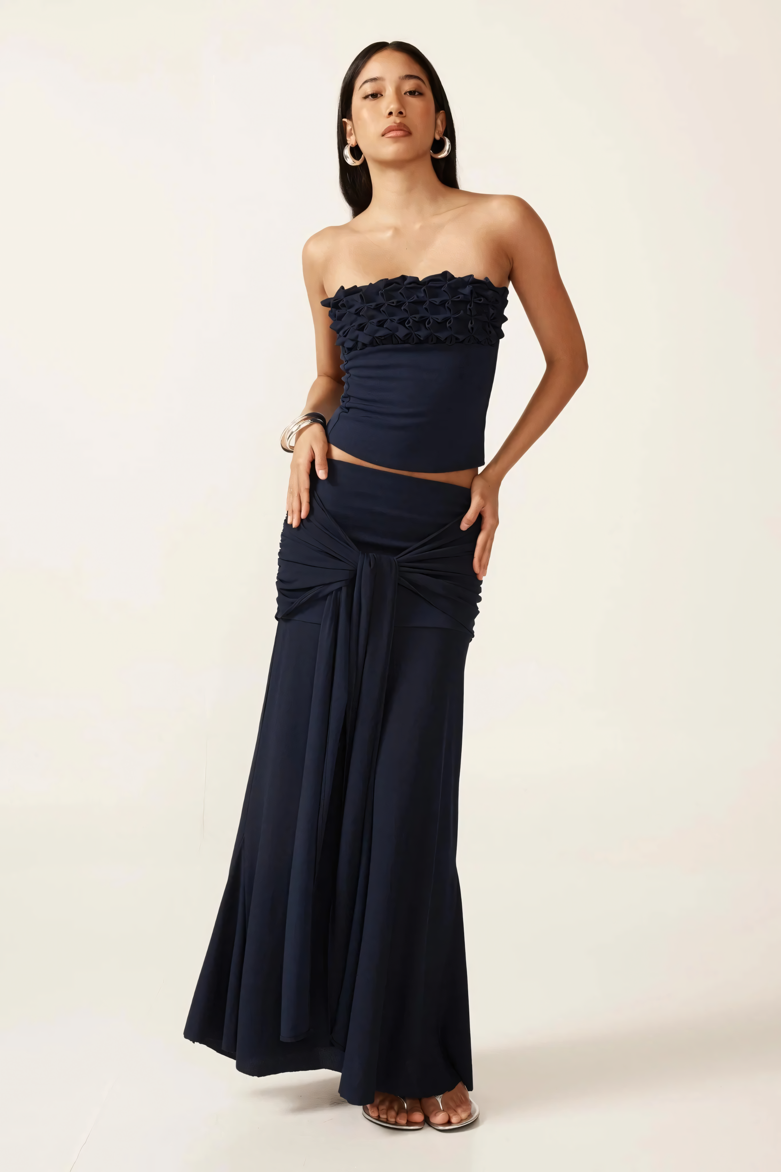 Navy strapless ruched crop top with textured ruffle neckline and matching maxi skirt with tie waist