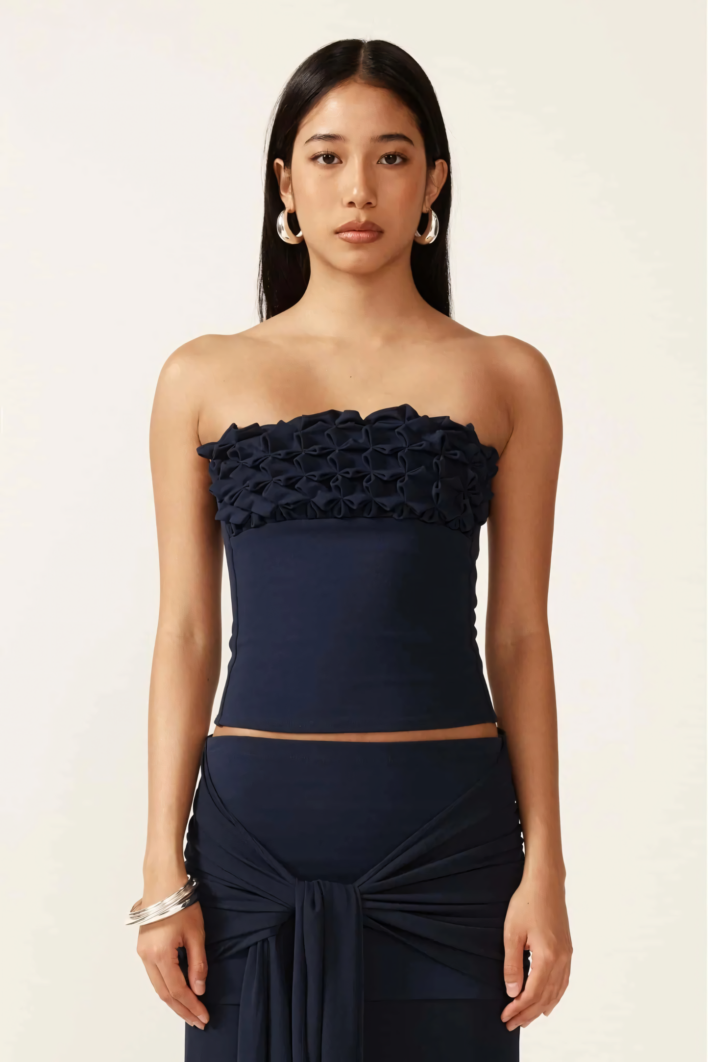 Navy strapless ruched crop top with gathered texture detail at neckline, front close-up