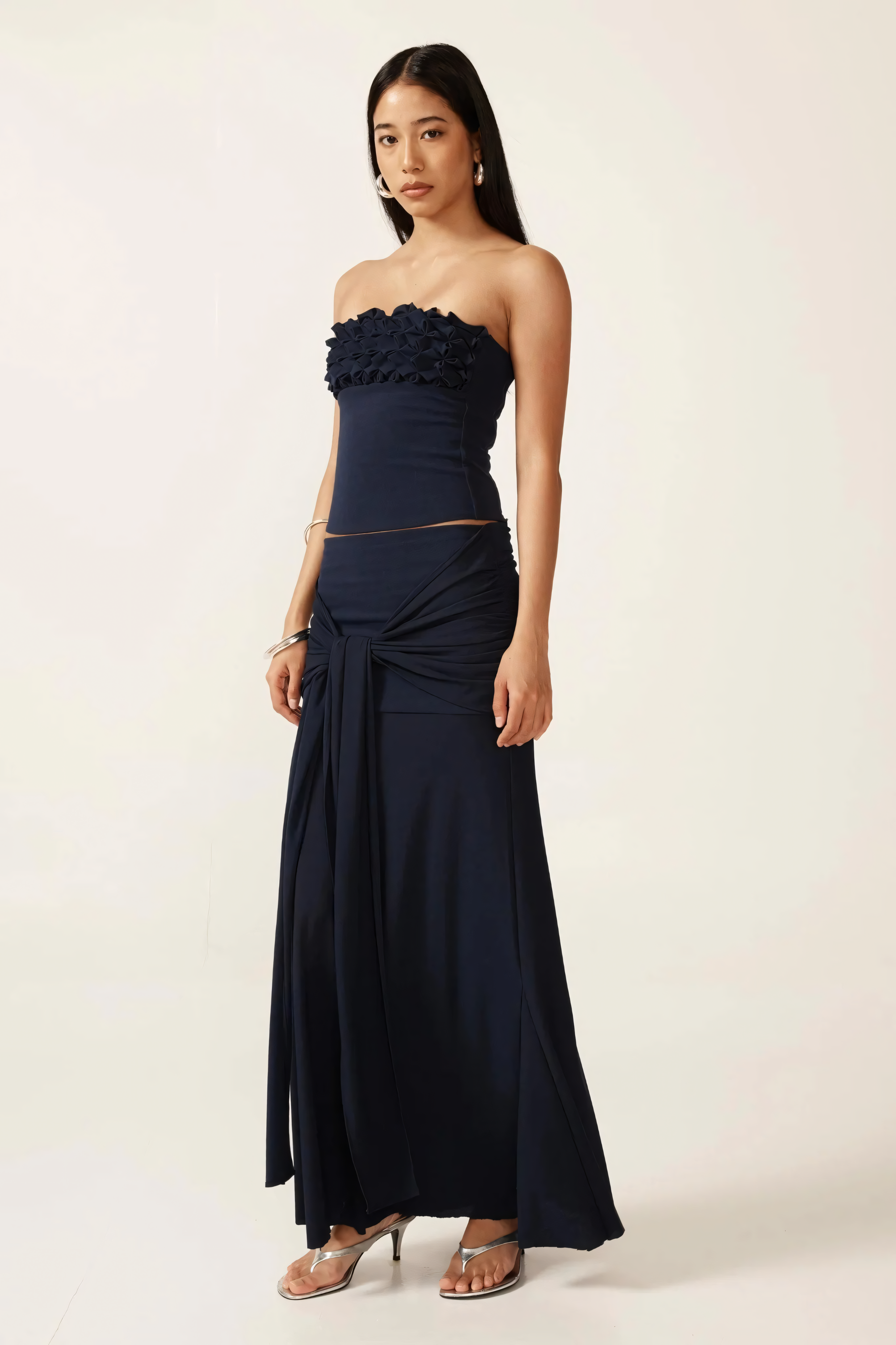 Navy ruched two-piece set with strapless crop top and tie-front maxi skirt, full length side view