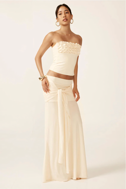 Cream strapless ruched crop top with textured ruffle neckline and matching maxi skirt with tie waist