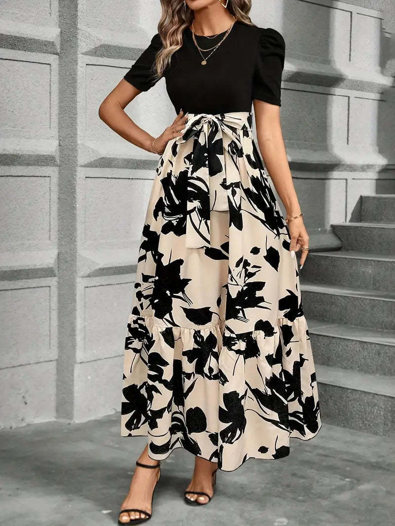 Fitted black top with adjustable tie waist and flowing floral maxi skirt detail