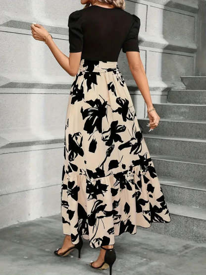 Back view of black puff sleeve dress with cream floral print and tiered skirt