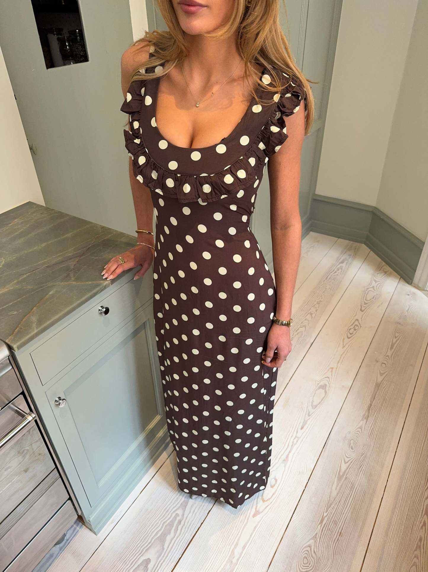 Brown polka dot maxi dress with ruffled off-shoulder neckline detail