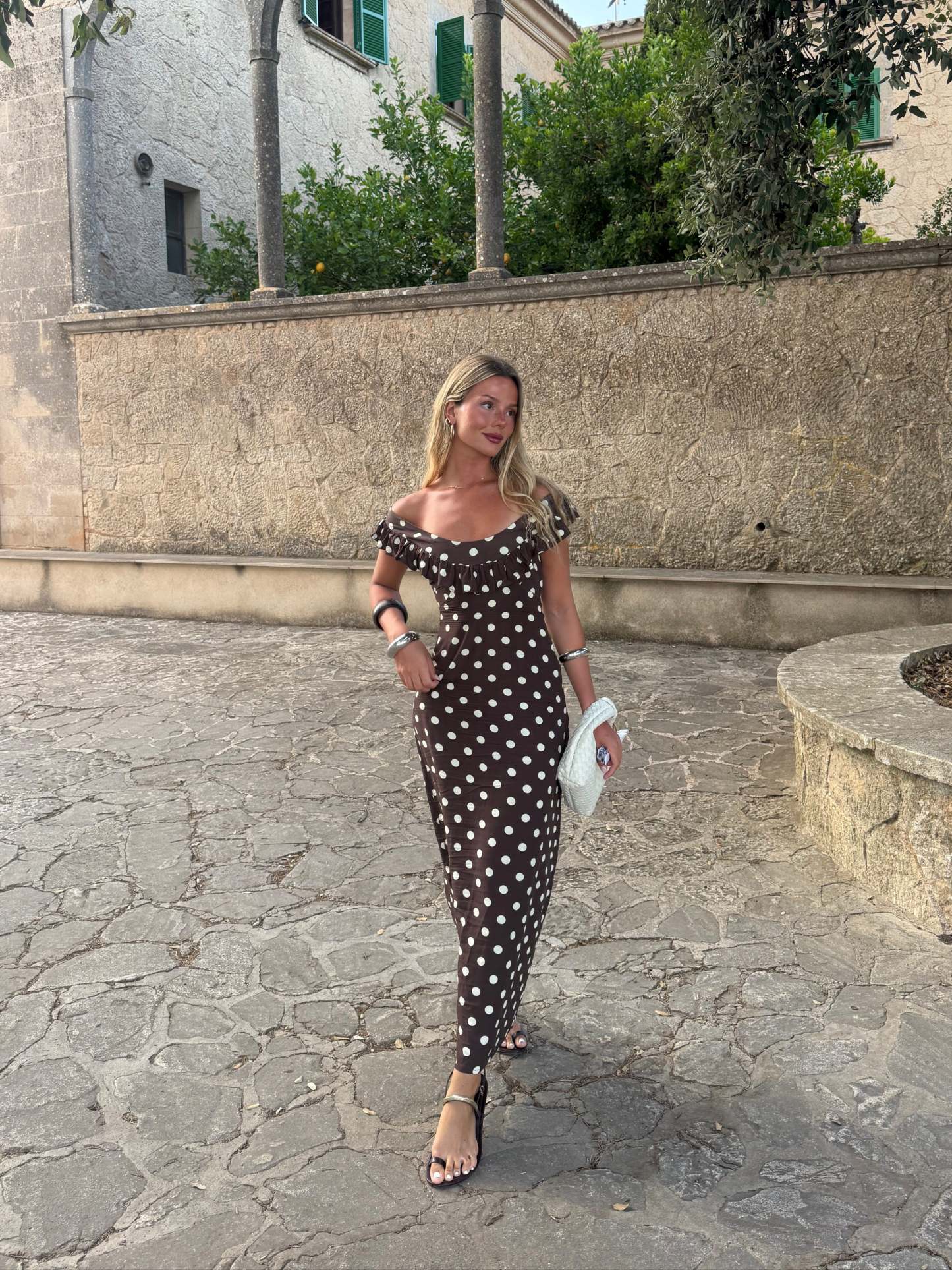 Full-length brown polka dot maxi dress with ruffled off-shoulder top