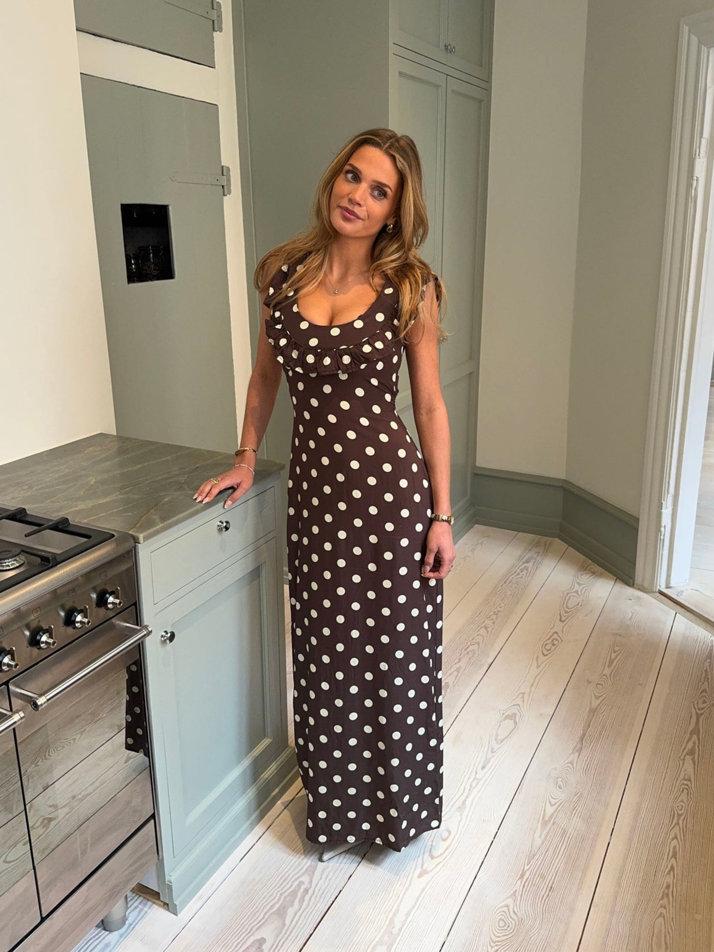 Brown polka dot maxi dress with ruffled neckline and short sleeves