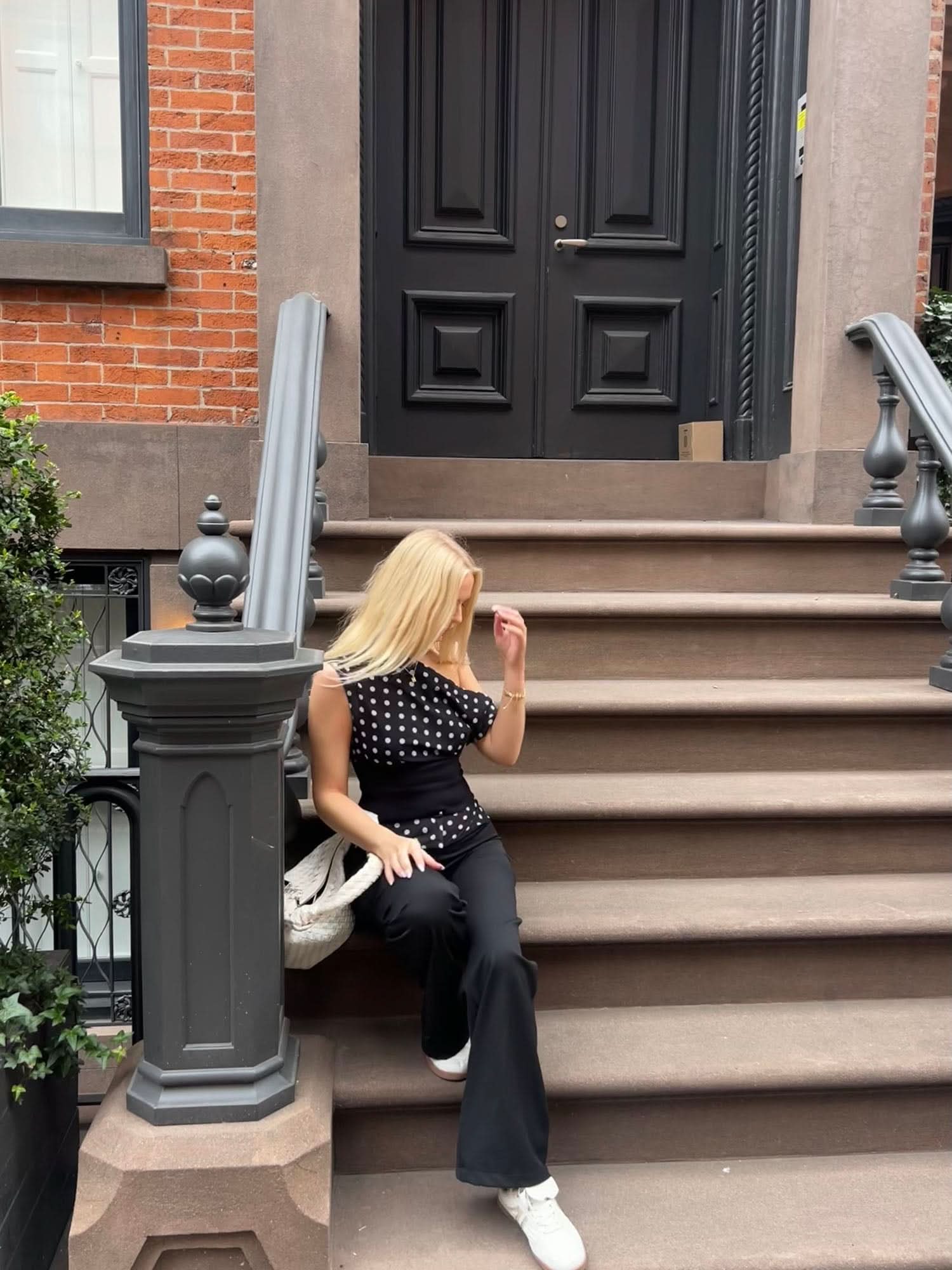 Black polka dot crop top styled with black flared pants