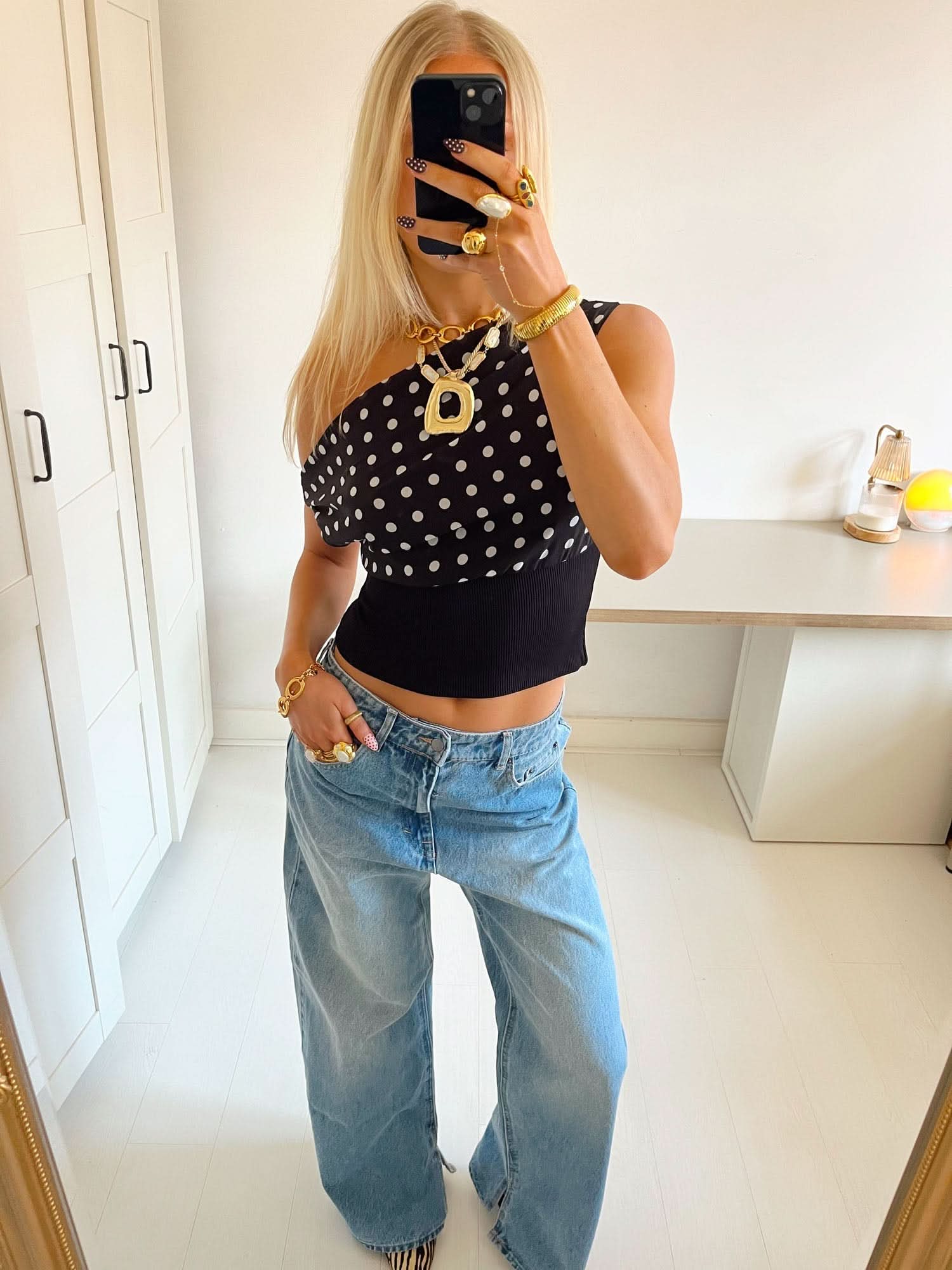 One-shoulder polka dot crop top with black ribbed band detail