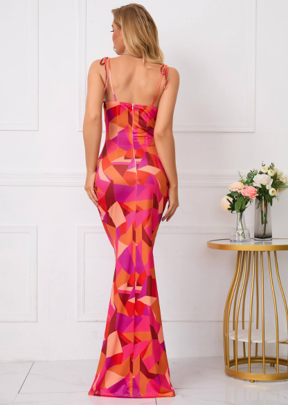 Back view of ruched maxi dress with geometric pink, orange, and red pattern