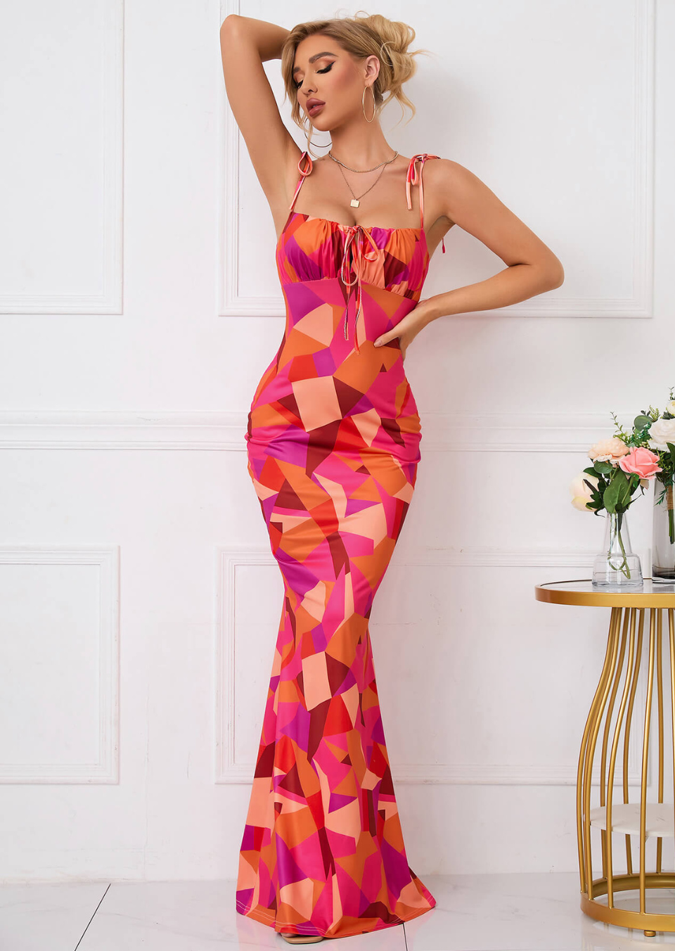 Front view of ruched maxi dress with tie-front neckline and colorful geometric print