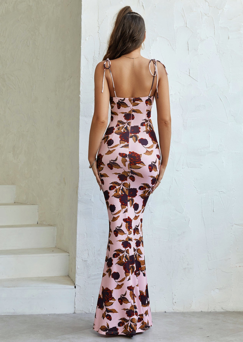 Back view of pink floral maxi dress with tie-shoulder straps and ruched fit