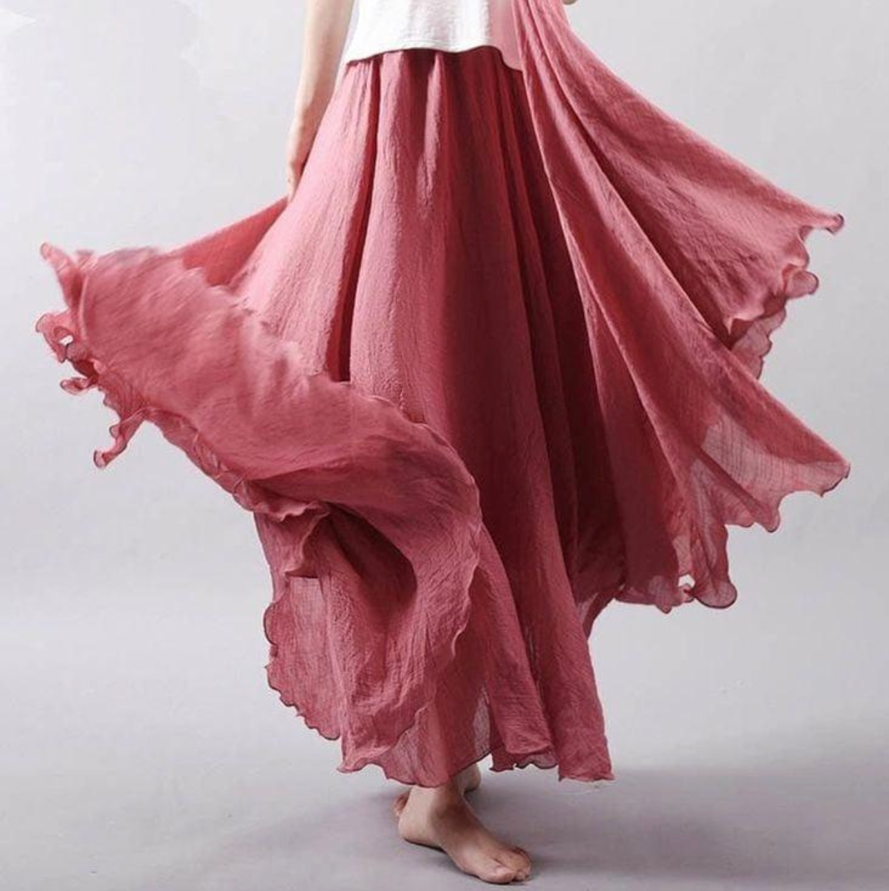 Rose pink pleated maxi skirt with ruffled hem and flowing fabric
