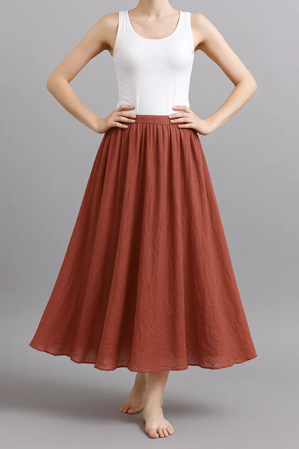 Rust red pleated maxi skirt with elasticated waist and full A-line silhouette