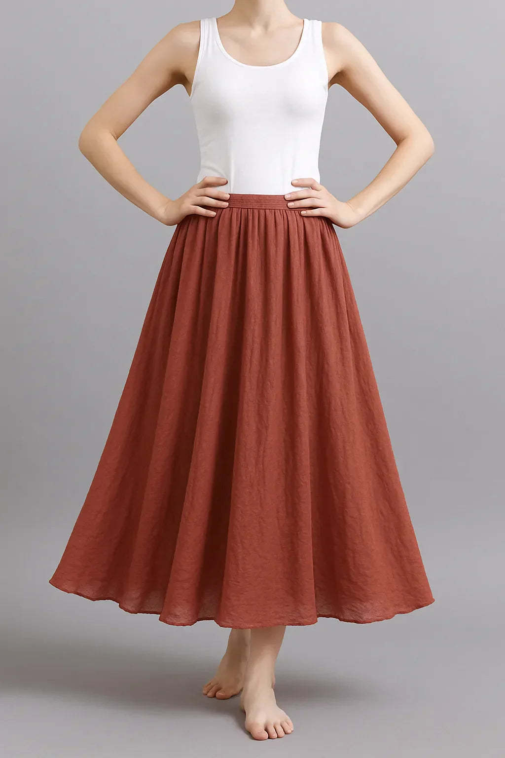 Rust red pleated maxi skirt with elasticated waist and full A-line silhouette