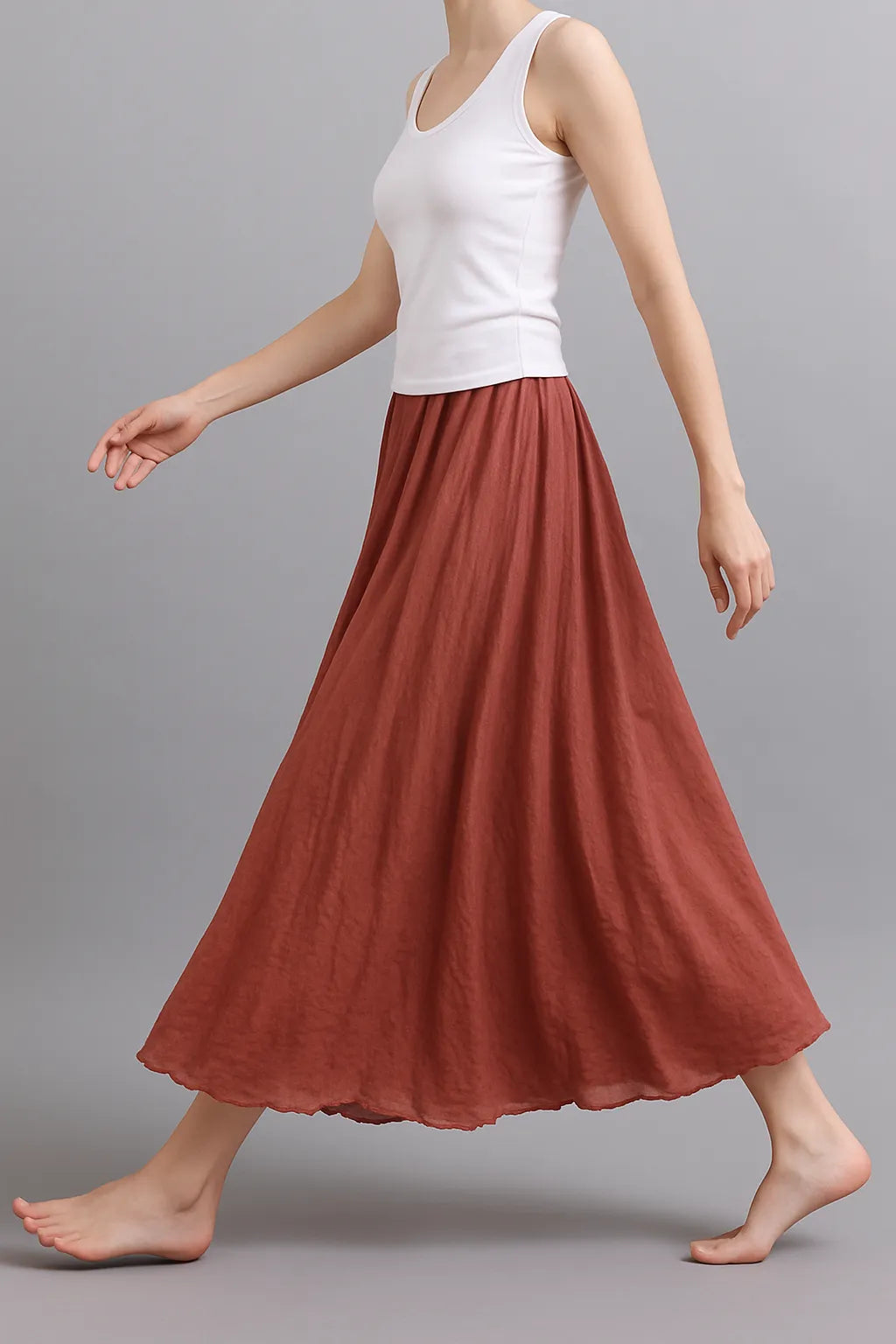 Rust pleated maxi skirt side view displaying elegant length and pleated construction