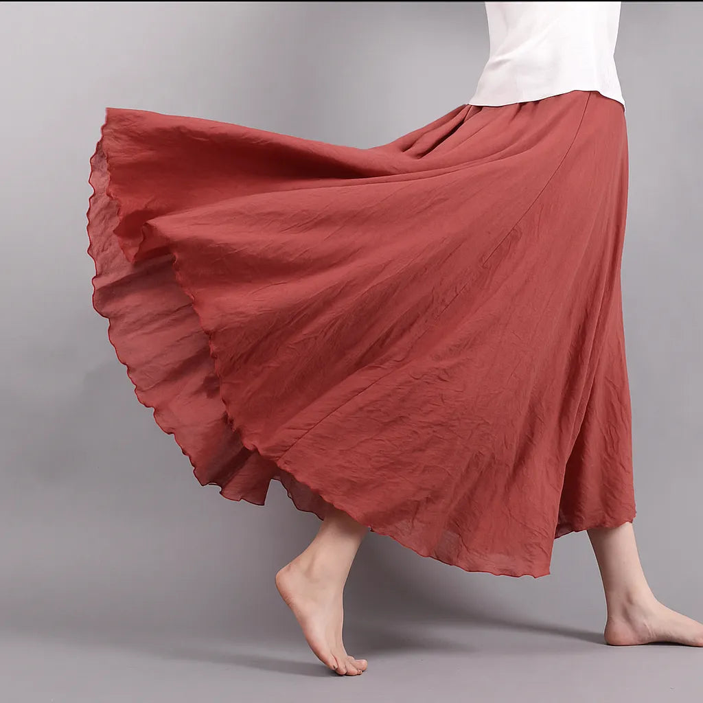 Burgundy pleated maxi skirt close-up of ruffled hem and flowing linen texture