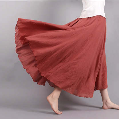 Burgundy pleated maxi skirt close-up of ruffled hem and flowing linen texture