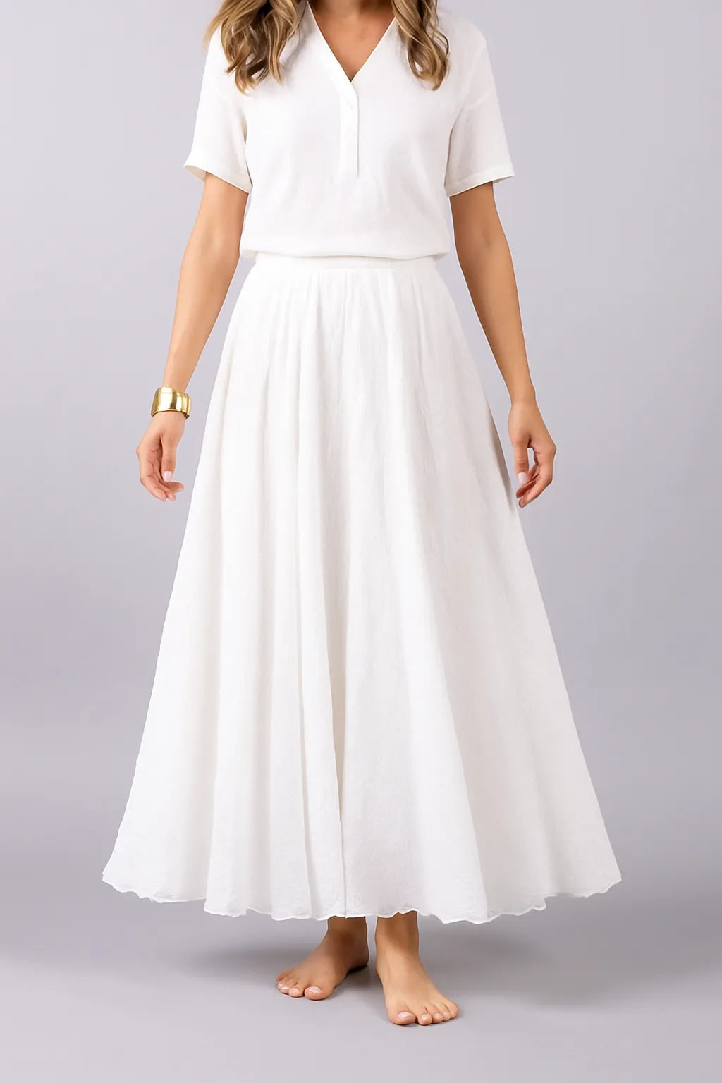 White pleated maxi skirt front view showing structured waistband