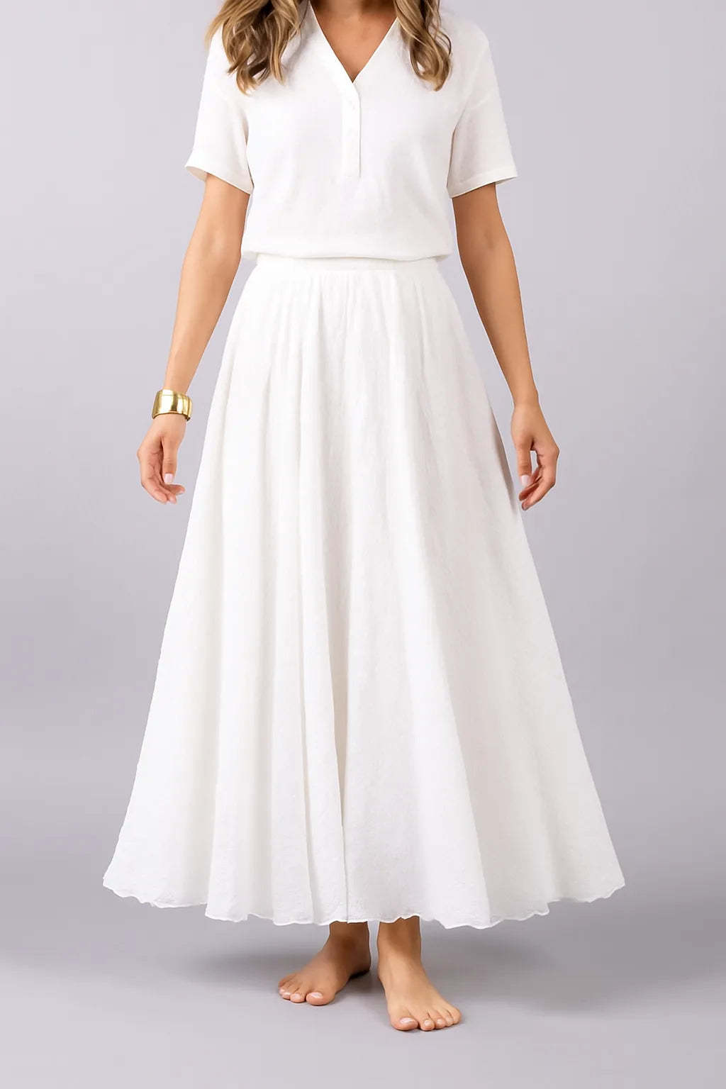 White pleated maxi skirt front view showing structured waistband