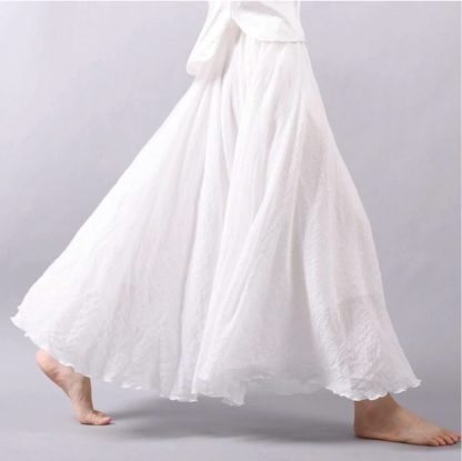 White pleated maxi skirt side view with full skirt movement
