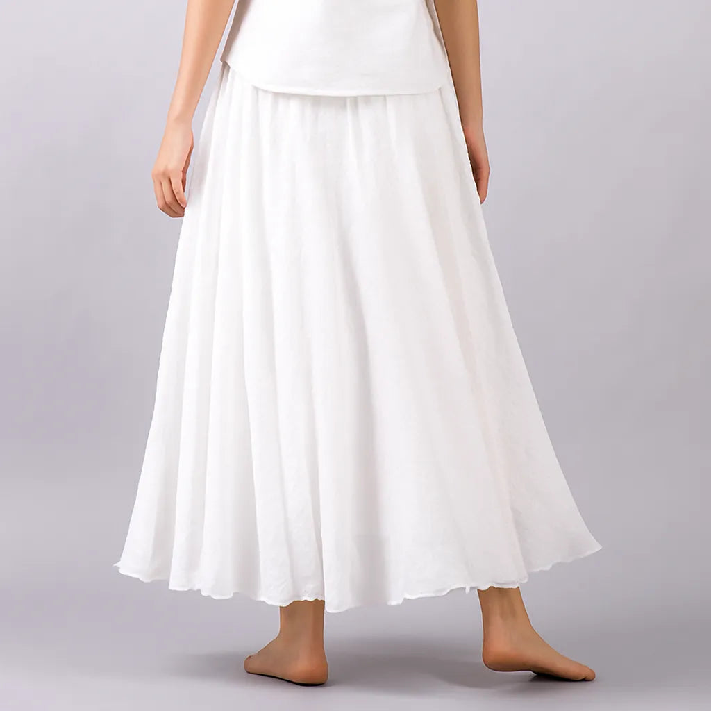White pleated maxi skirt detail showing fine pleats and hem