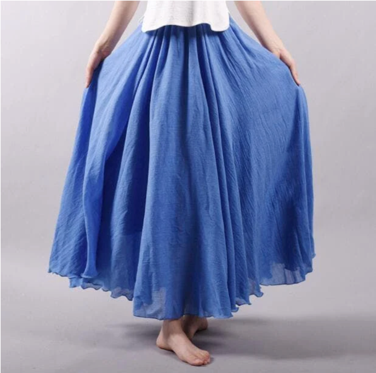 Blue pleated maxi skirt with deep color and voluminous folds