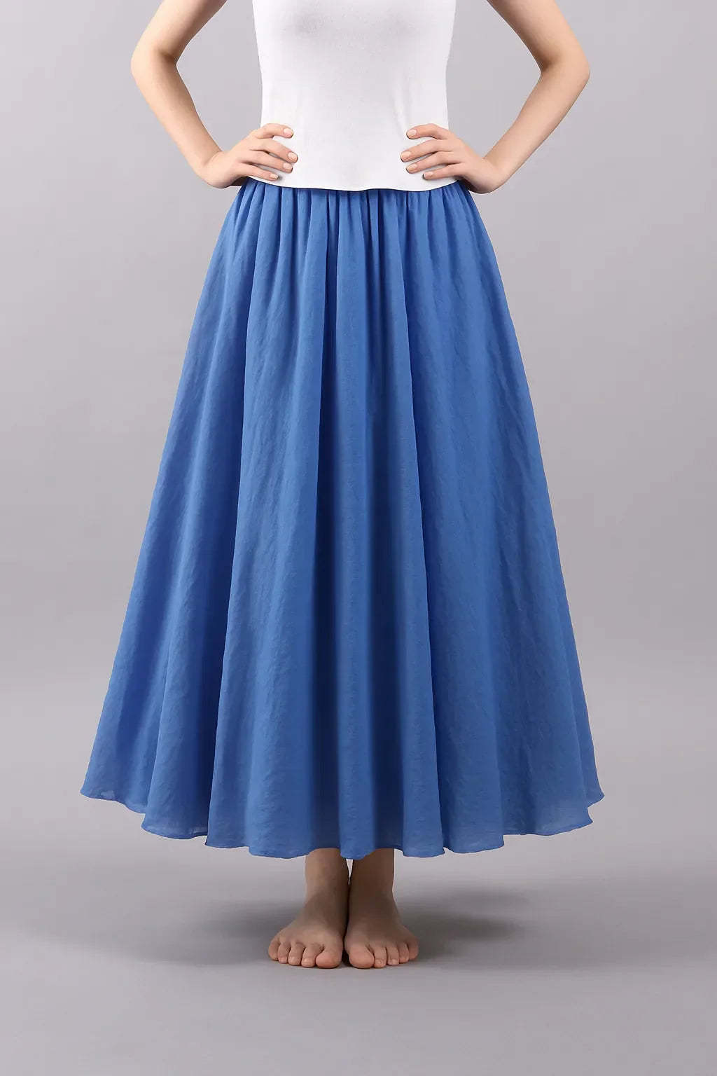 Blue pleated maxi skirt front view with structured waist detail