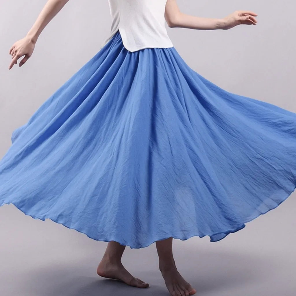 Blue pleated maxi skirt in motion showing graceful drape