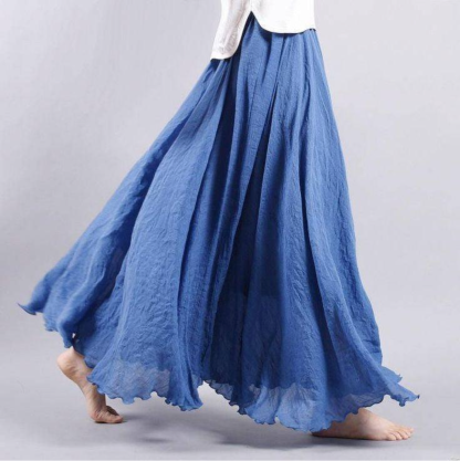 Blue pleated maxi skirt side profile with flowing fabric layers