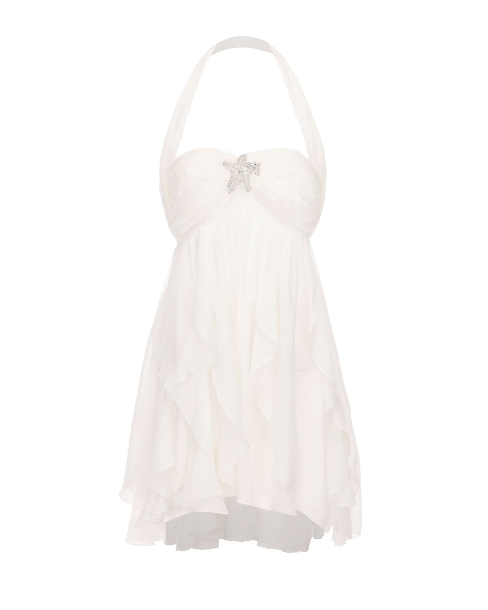 Cream halter mini dress with ruffled skirt and star brooch detail