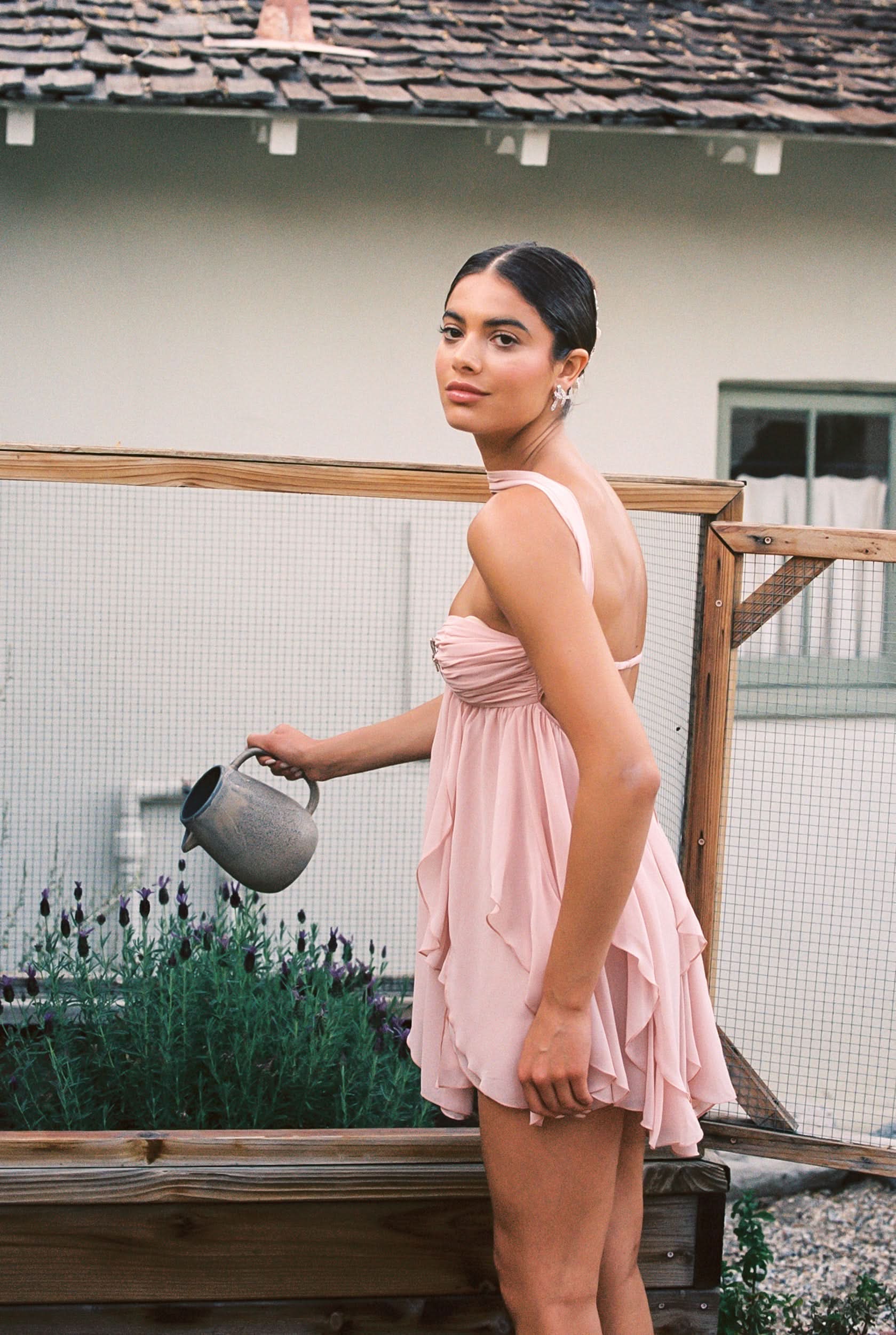 Blush pink ruffled halter mini dress with star brooch and flowing layers