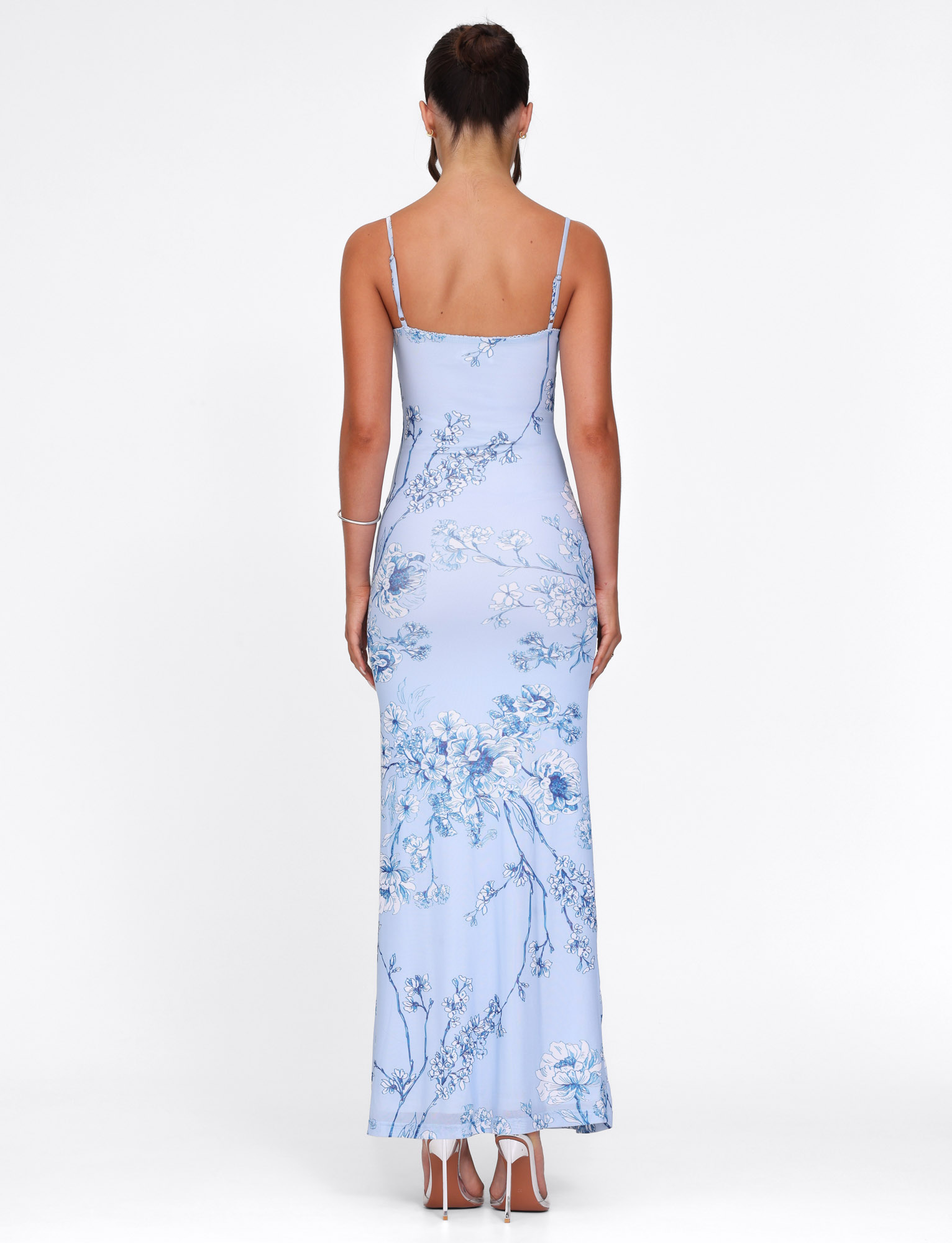 Back view of light blue floral maxi dress showing open back design