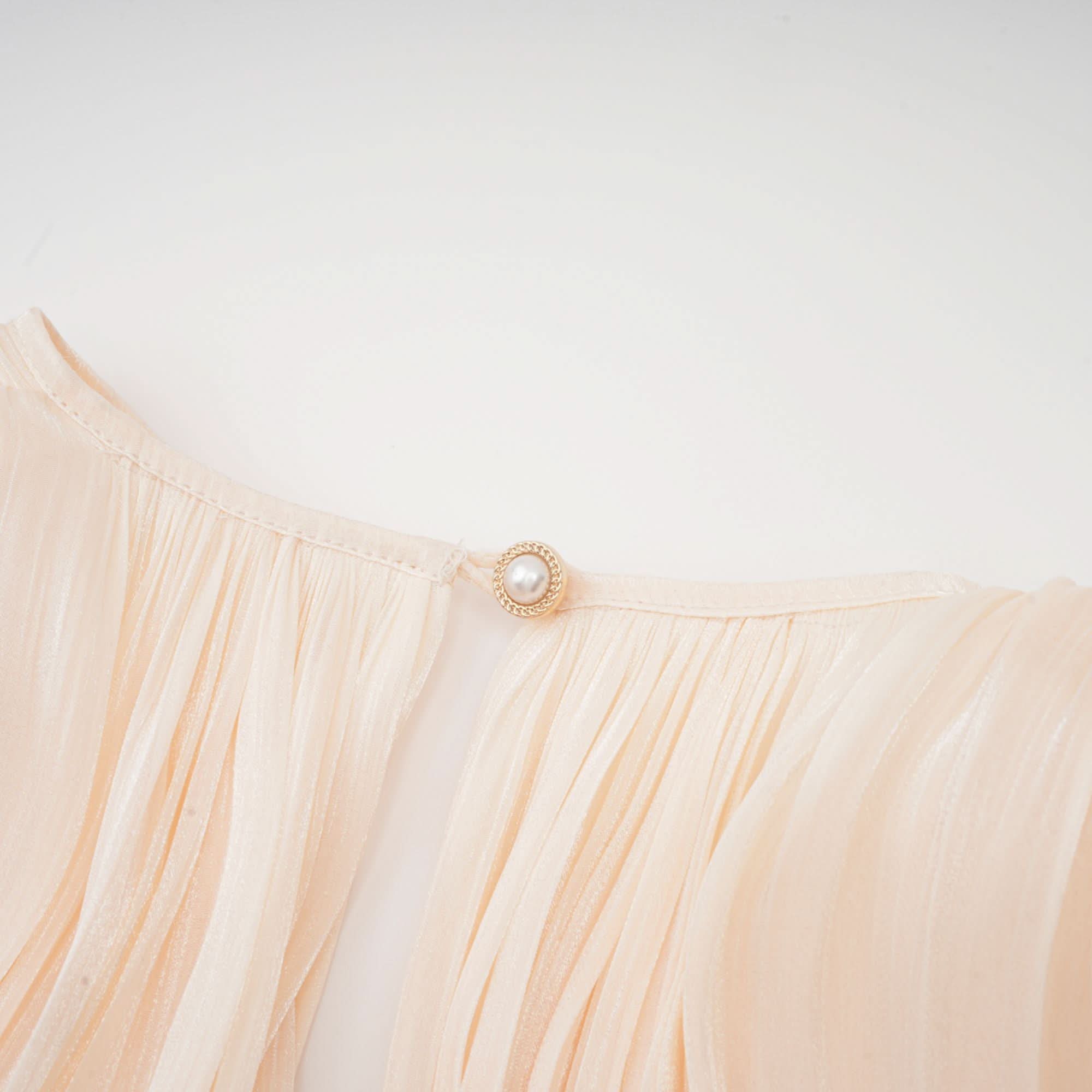 Pearl button detail on cream pleated ruffle dress waist tie