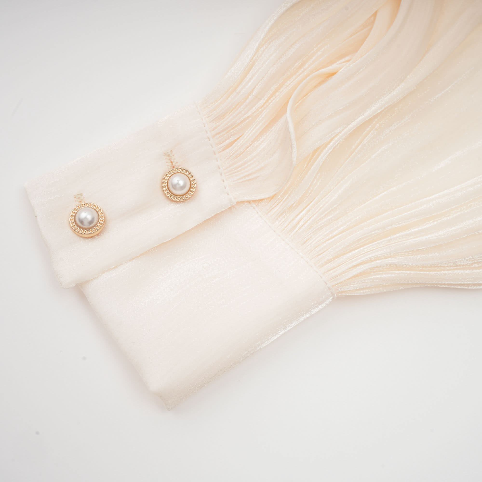 Flowing cream pleated ruffle hem with delicate layered edges