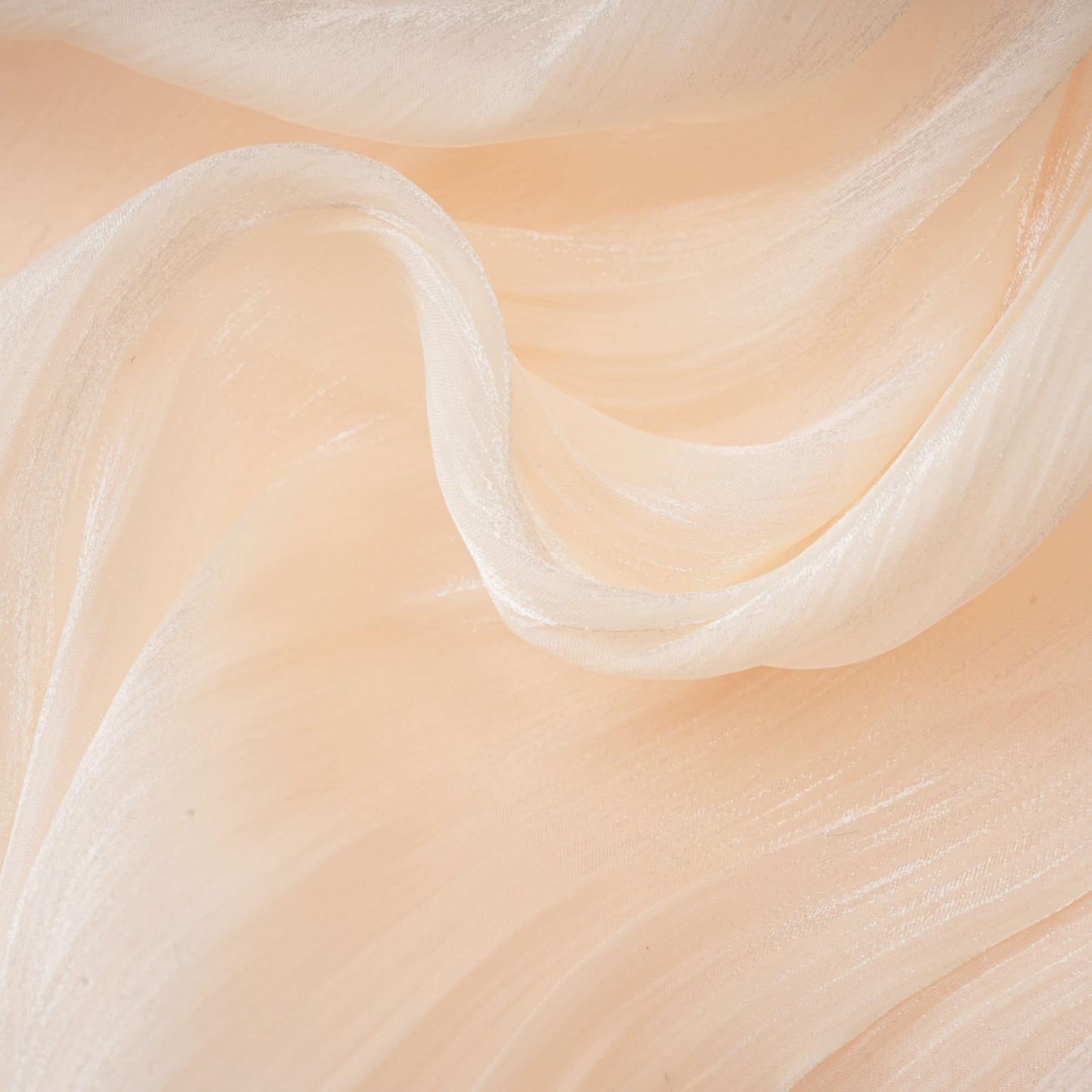 Layered ruffle edge on cream mini dress showing soft fabric drape