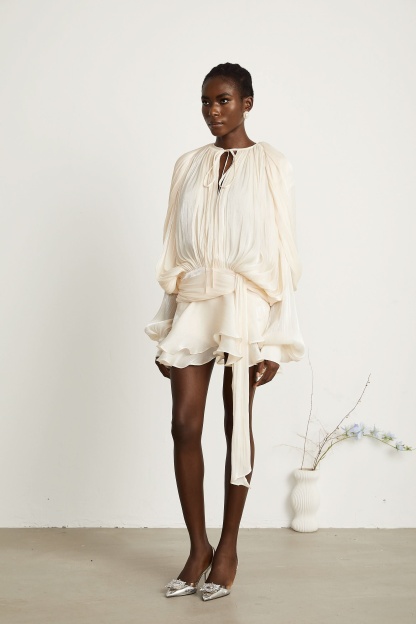 Cream pleated mini dress with tie waist and layered ruffle skirt