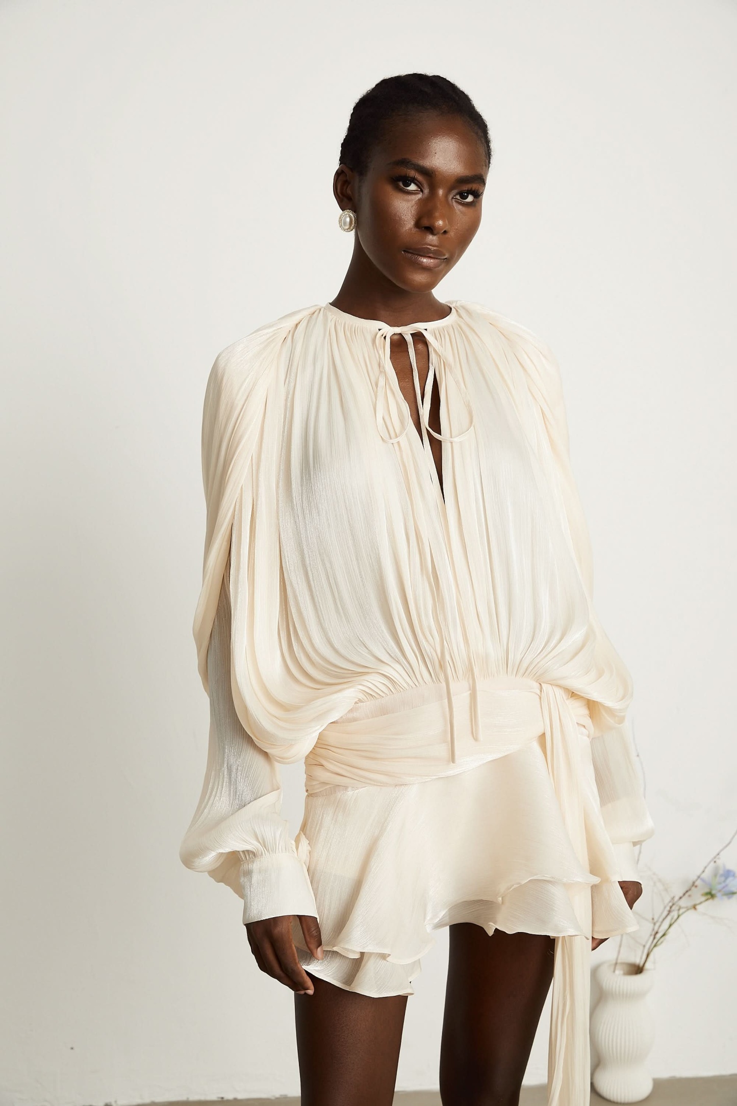 Cream ruffle mini dress with draped sleeves and gathered waist