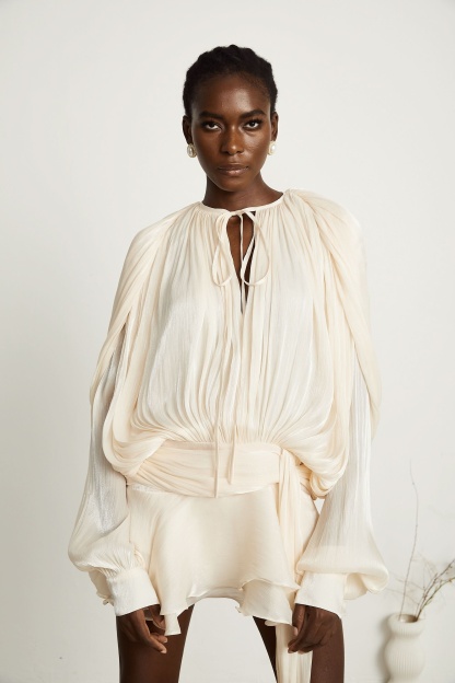 Cream pleated mini dress with tie-neck closure and voluminous sleeves
