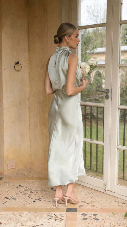 Side profile of sage draped midi dress with open back detail