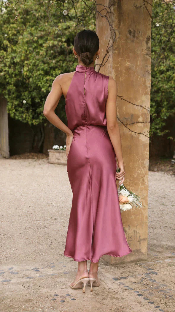 Back view of mauve draped midi dress with button detail