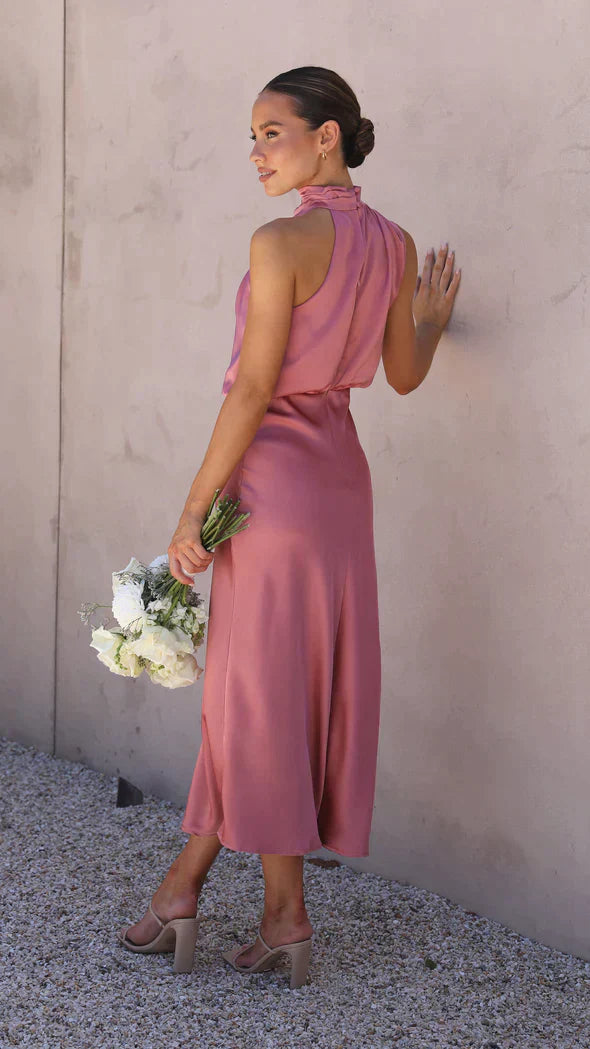 Back view of rose pink draped midi dress showing open back
