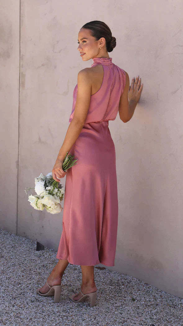 Back view of rose pink draped midi dress showing open back