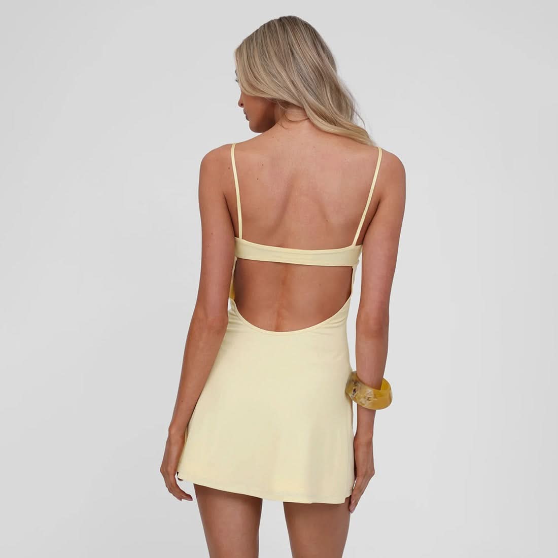Back view of pale yellow sequin dress with open cutout detail