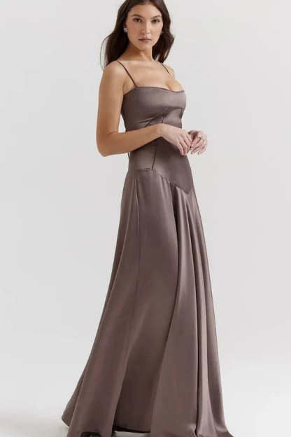 Front view of taupe maxi dress with structured corset and pleated skirt