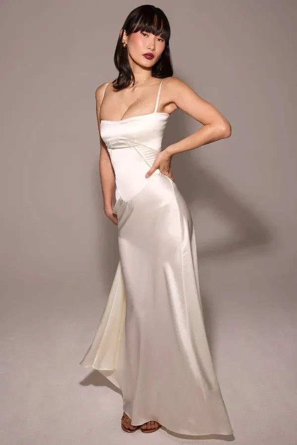 Ivory corset maxi dress with draped skirt and fitted bodice, side view