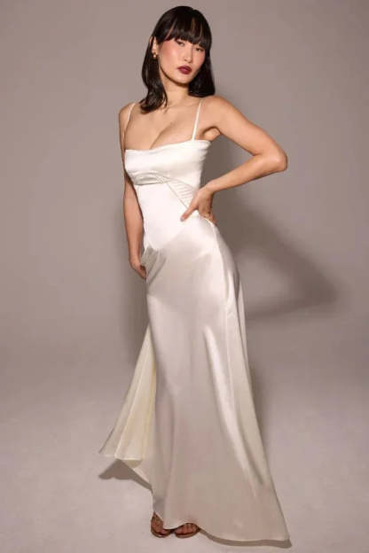 Ivory corset maxi dress with draped skirt and fitted bodice, side view