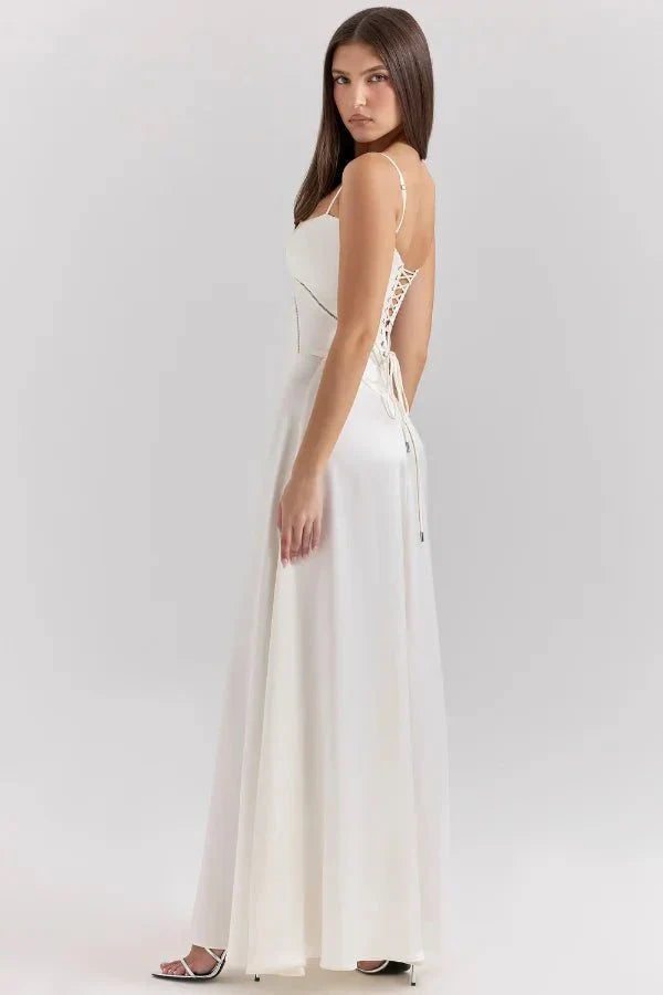 Back angle of ivory corset maxi dress with lace-up closure and flowing skirt