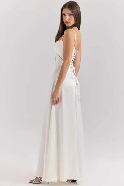 Back angle of ivory corset maxi dress with lace-up closure and flowing skirt